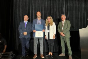 A photo of Shields with the Early Achievement Research Award