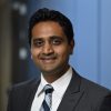 A headshot of Vishal Patel wearing a gray suit over a white shirt and a tie.